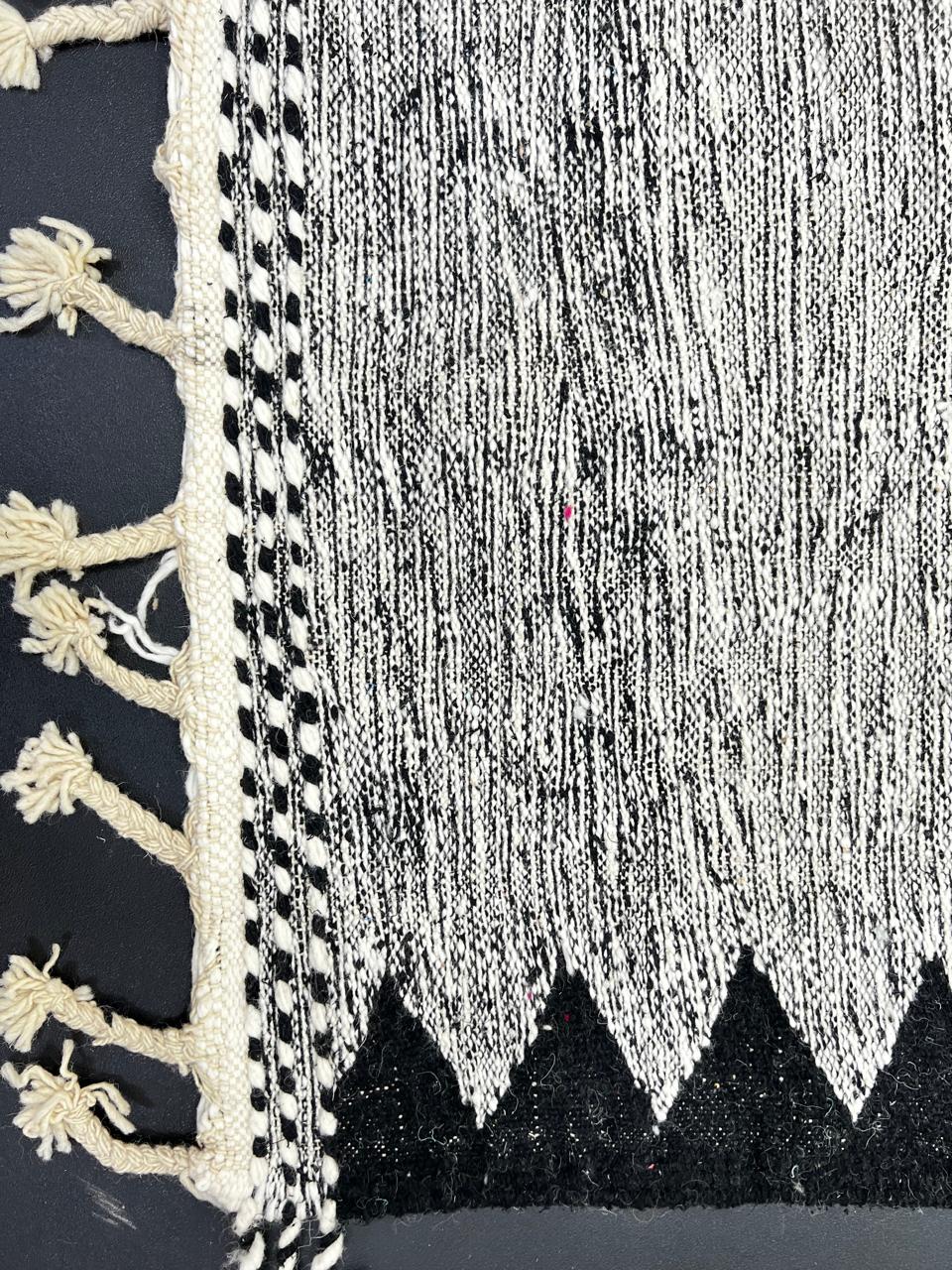 Handmade black and white Moroccan kilim runner rug with bold zigzag geometric pattern and flatwoven wool texture