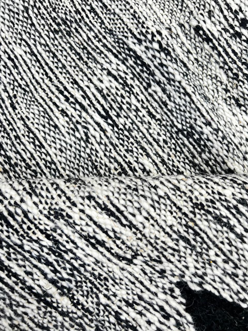 Handmade black and white Moroccan kilim runner rug with bold zigzag geometric pattern and flatwoven wool texture