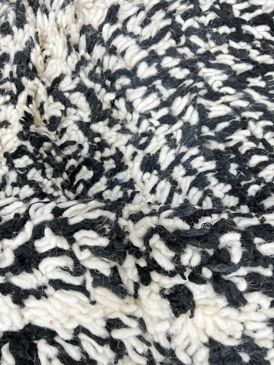 Handmade black and white Moroccan runner rug with diamond lattice pattern in natural wool, Beni Ourain style shag runner.