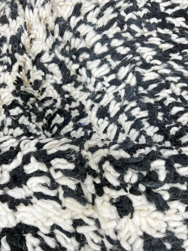 Handmade black and white Moroccan runner rug with diamond lattice pattern in natural wool, Beni Ourain style shag runner.