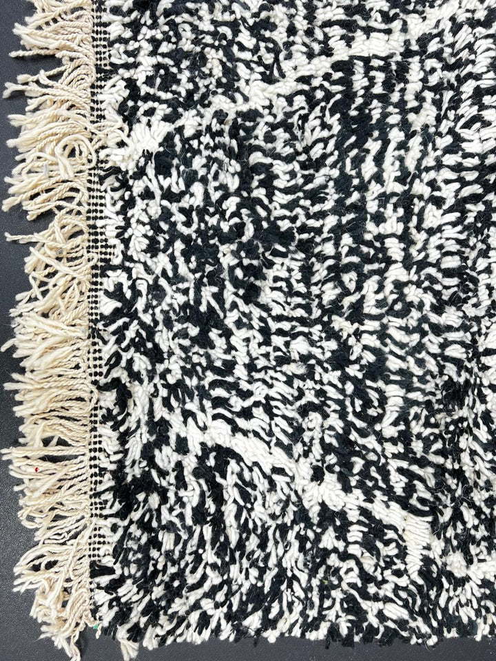 Handmade black and white Moroccan runner rug with diamond lattice pattern in natural wool, Beni Ourain style shag runner.