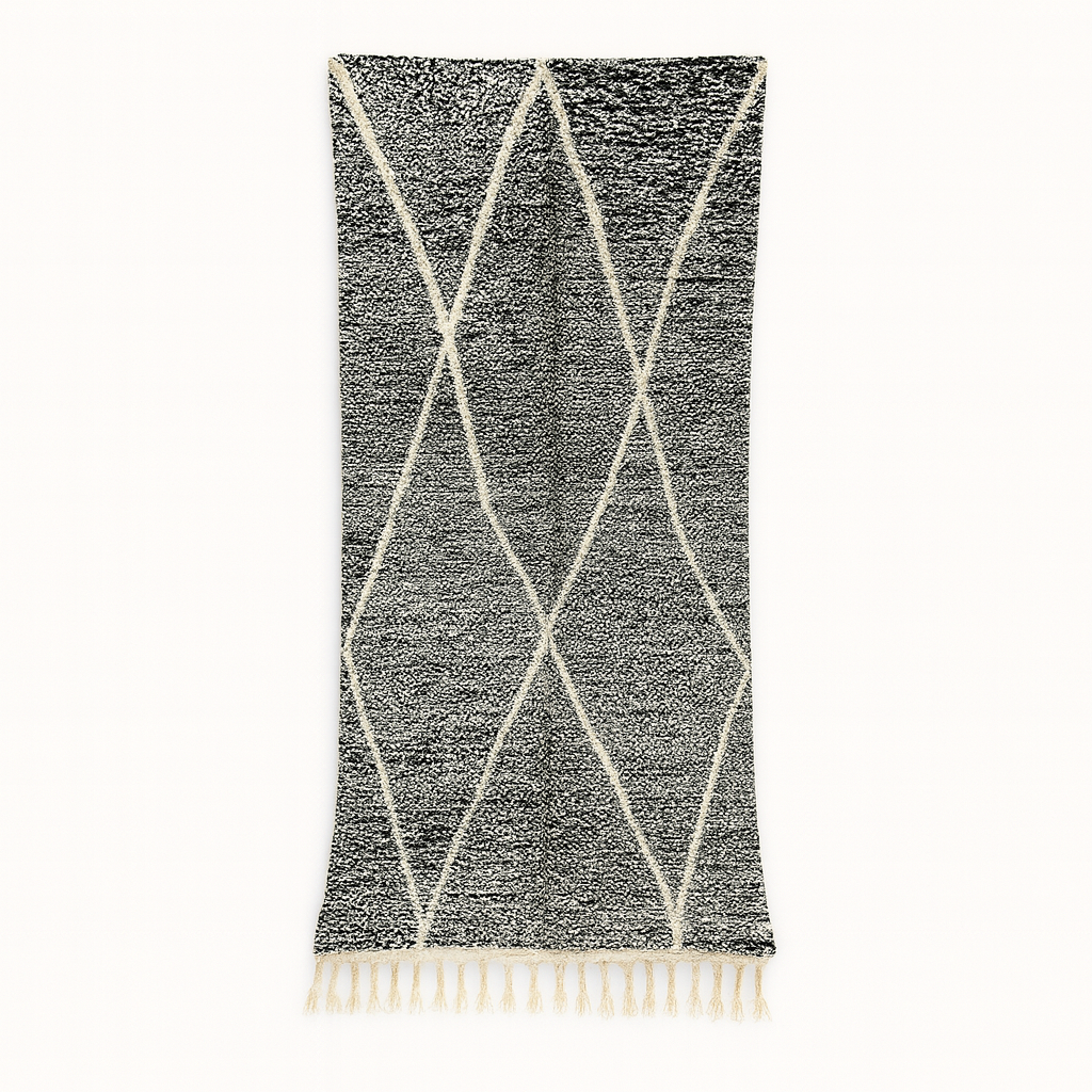 Black and white Moroccan wool runner rug with geometric diamond pattern and tassels, handmade by Berber artisans