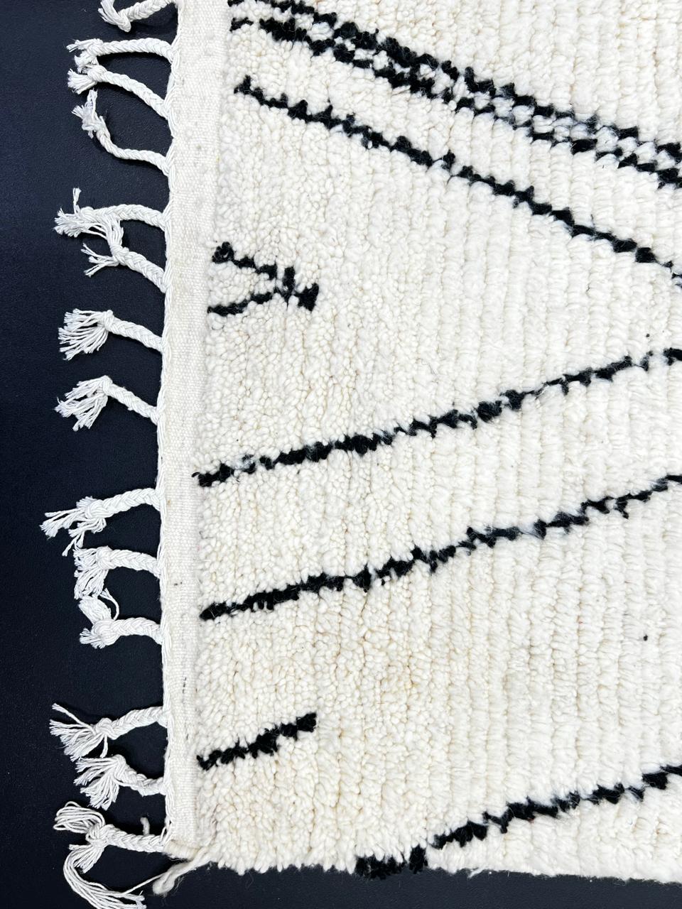 Handmade black and white Moroccan runner rug with minimalist Berber symbols and white wool base