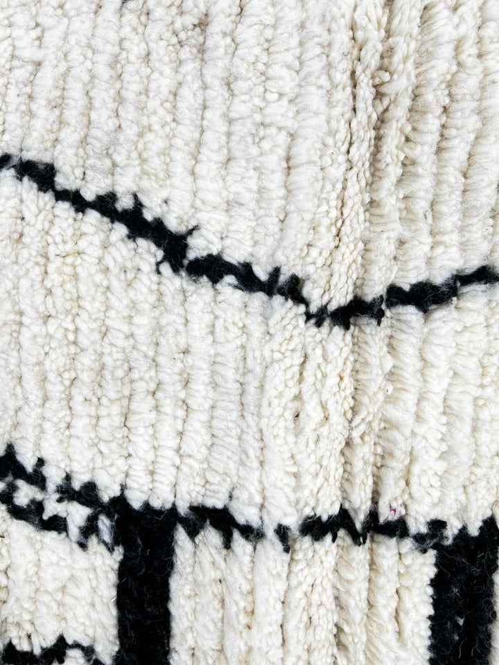 Handmade black and white Moroccan runner rug with minimalist Berber symbols and white wool base