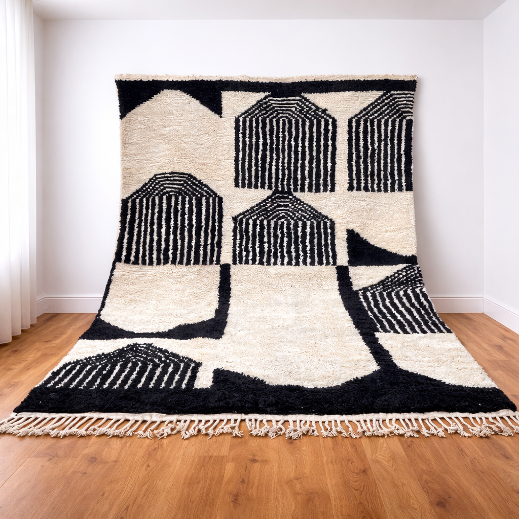 Black and white Moroccan Berber wool rug with architectural geometric pattern, handmade shag rug with tassels in modern living room