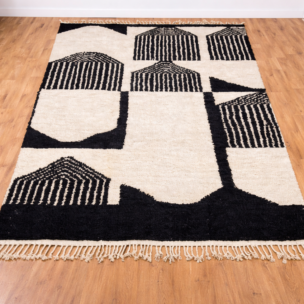 Black and white Moroccan Berber wool rug with architectural geometric pattern, handmade shag rug with tassels in modern living room