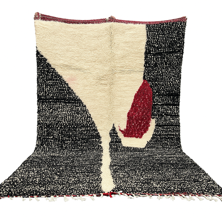 Handmade Moroccan wool rug with abstract black, cream, and red geometric design