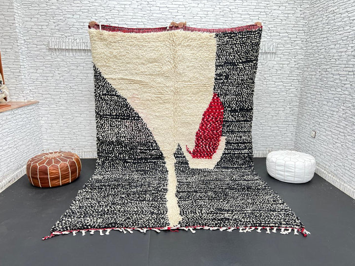 Handmade Moroccan wool rug with abstract black, cream, and red geometric design