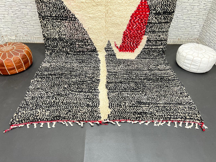 Handmade Moroccan wool rug with abstract black, cream, and red geometric design