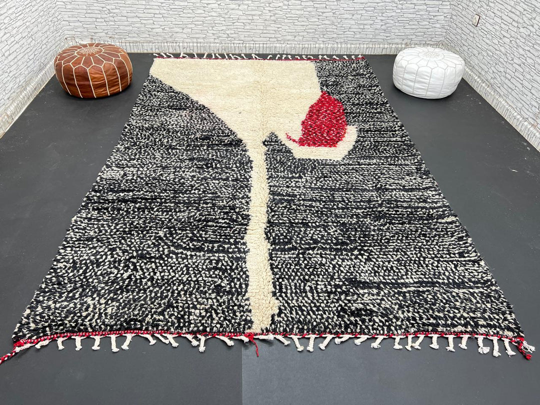 Handmade Moroccan wool rug with abstract black, cream, and red geometric design
