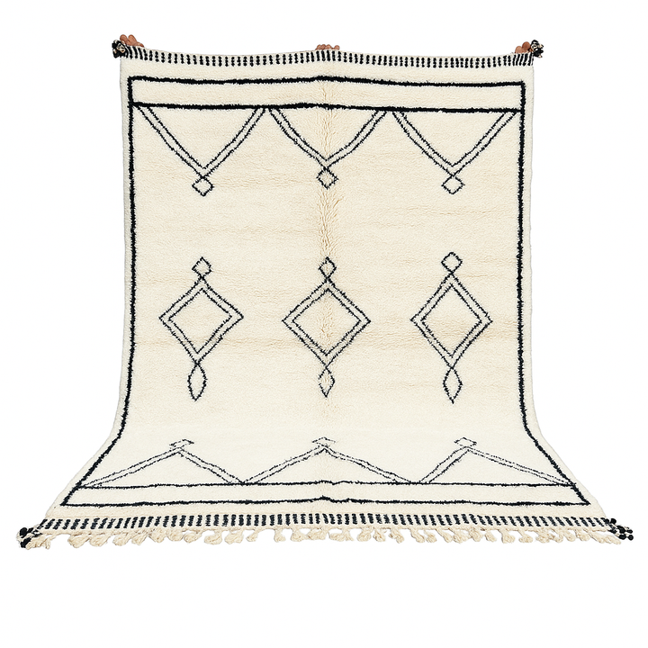 Black and white handmade Beni Ourain Moroccan wool rug with geometric diamond design and fringed edges