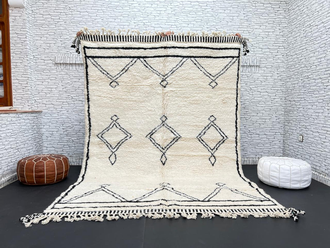 Black and white handmade Beni Ourain Moroccan wool rug with geometric diamond design and fringed edges