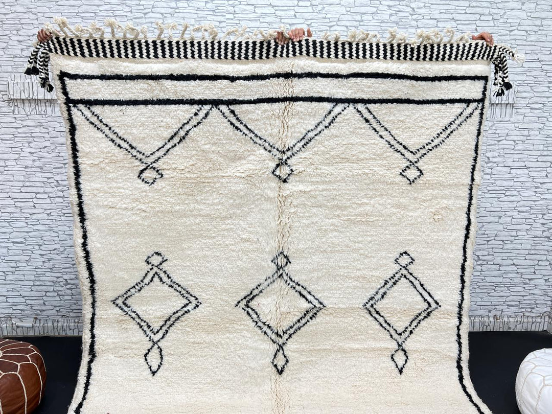 Black and white handmade Beni Ourain Moroccan wool rug with geometric diamond design and fringed edges