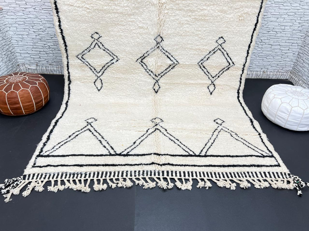 Black and white handmade Beni Ourain Moroccan wool rug with geometric diamond design and fringed edges
