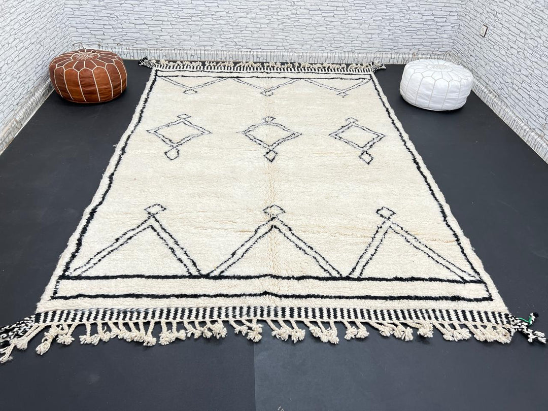 Black and white handmade Beni Ourain Moroccan wool rug with geometric diamond design and fringed edges