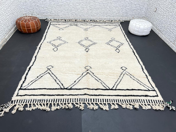 Black and white handmade Beni Ourain Moroccan wool rug with geometric diamond design and fringed edges