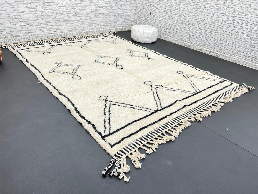 Black and white handmade Beni Ourain Moroccan wool rug with geometric diamond design and fringed edges