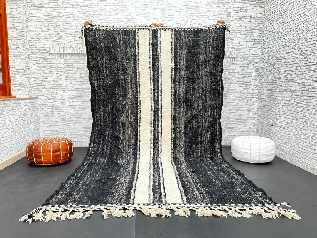 Black and white Moroccan wool rug with vertical stripe design, handmade by Berber artisans