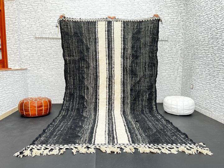 Black and white Moroccan wool rug with vertical stripe design, handmade by Berber artisans