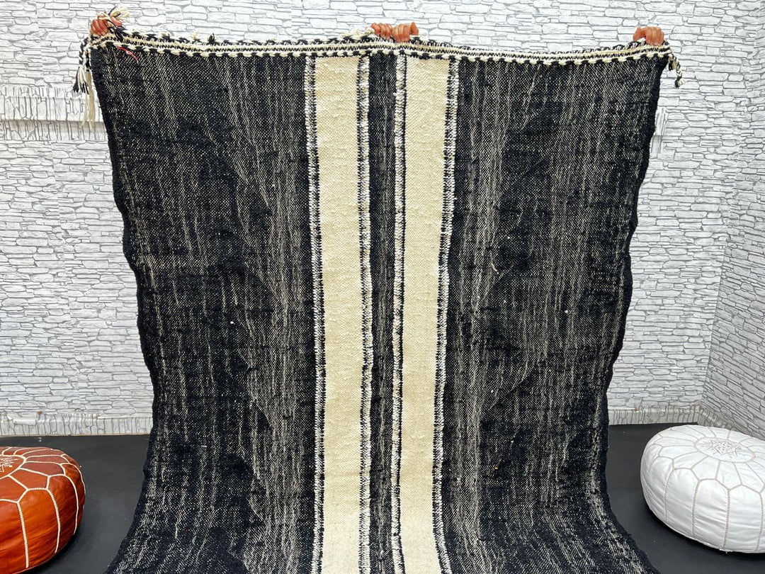 Black and white Moroccan wool rug with vertical stripe design, handmade by Berber artisans