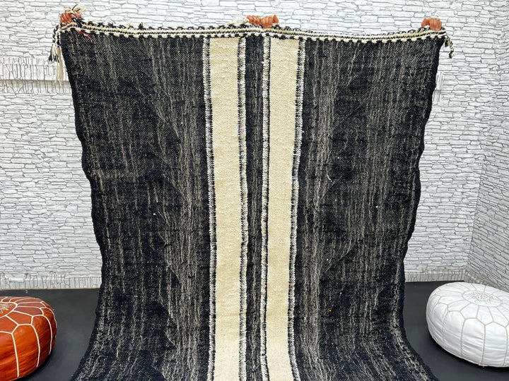 Black and white Moroccan wool rug with vertical stripe design, handmade by Berber artisans
