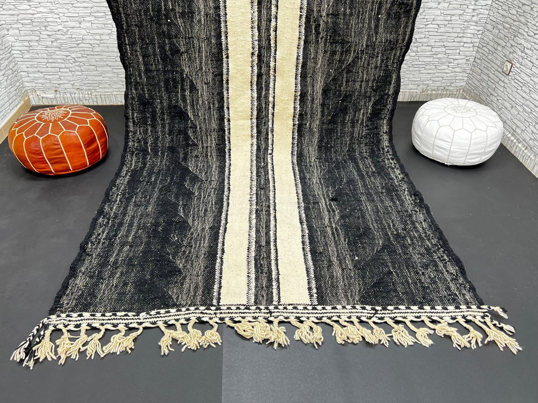 Black and white Moroccan wool rug with vertical stripe design, handmade by Berber artisans