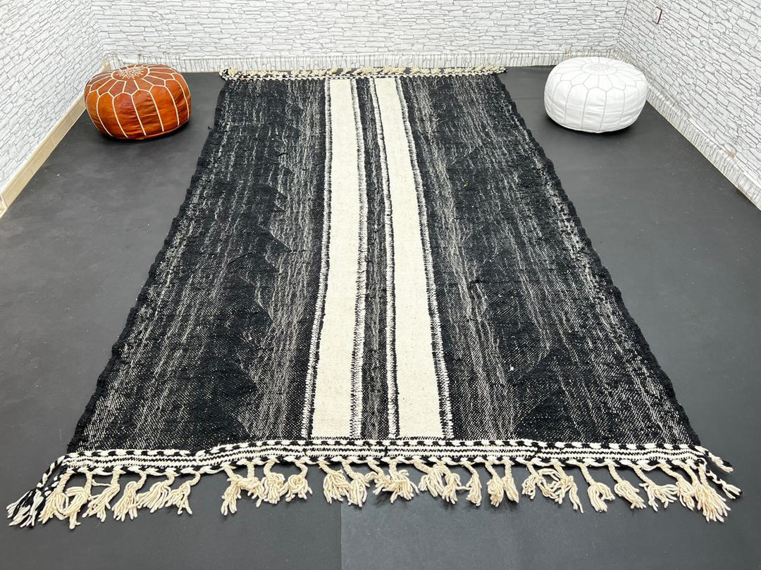 Black and white Moroccan wool rug with vertical stripe design, handmade by Berber artisans