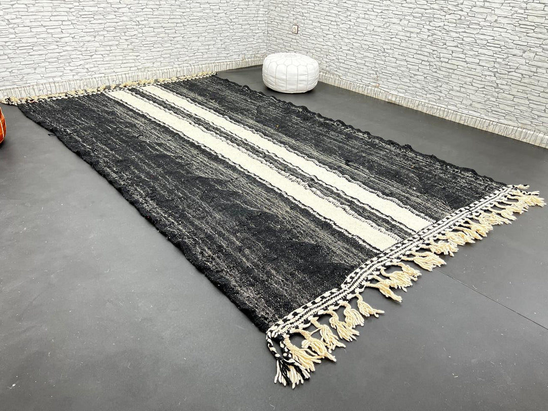 Black and white Moroccan wool rug with vertical stripe design, handmade by Berber artisans