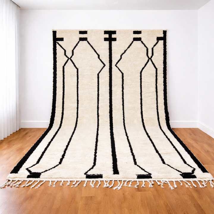 Black and white Moroccan Berber wool rug with linear geometric pattern, handmade plush shag rug with tassels