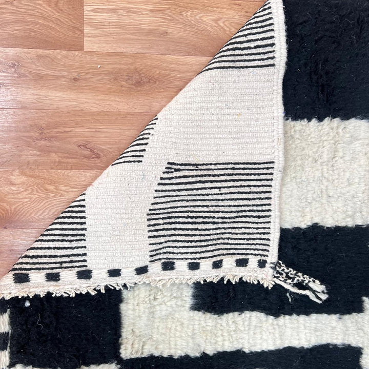 Black and white Moroccan wool runner rug with abstract Berber geometric pattern