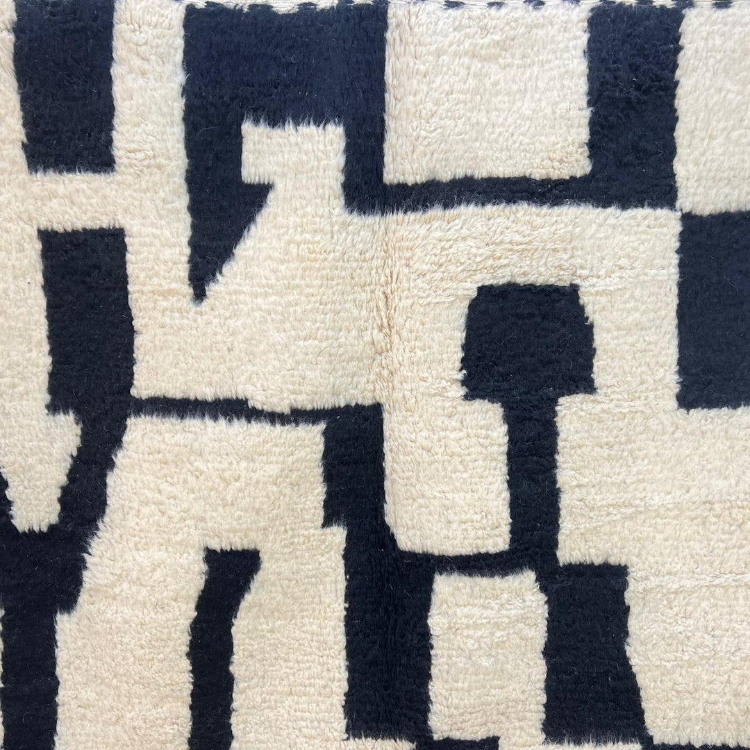Black and white Moroccan wool runner rug with abstract Berber geometric pattern
