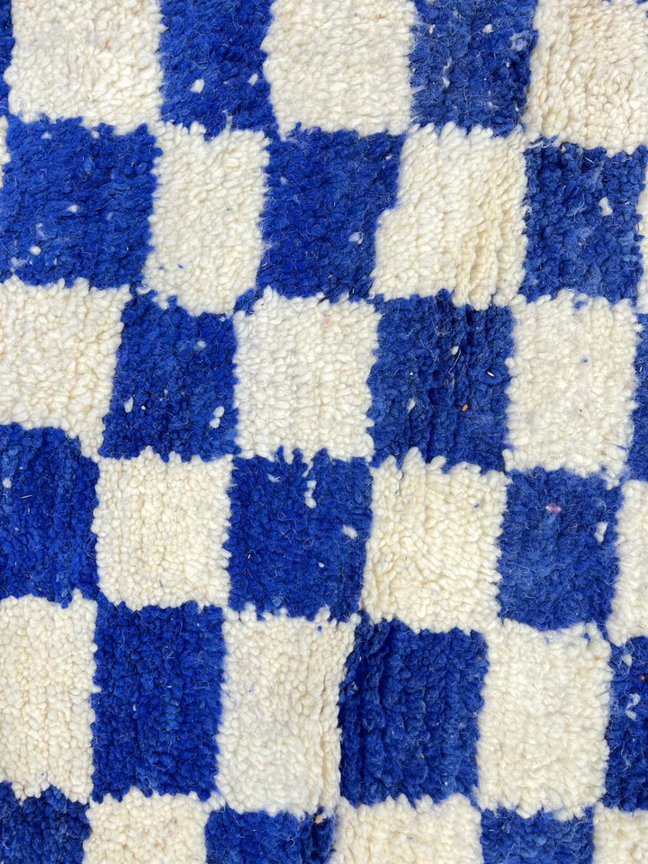 Handmade Moroccan runner rug with blue and white checkerboard pattern crafted from natural wool.