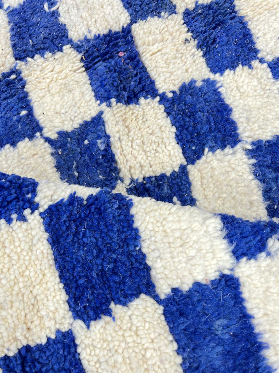 Handmade Moroccan runner rug with blue and white checkerboard pattern crafted from natural wool.