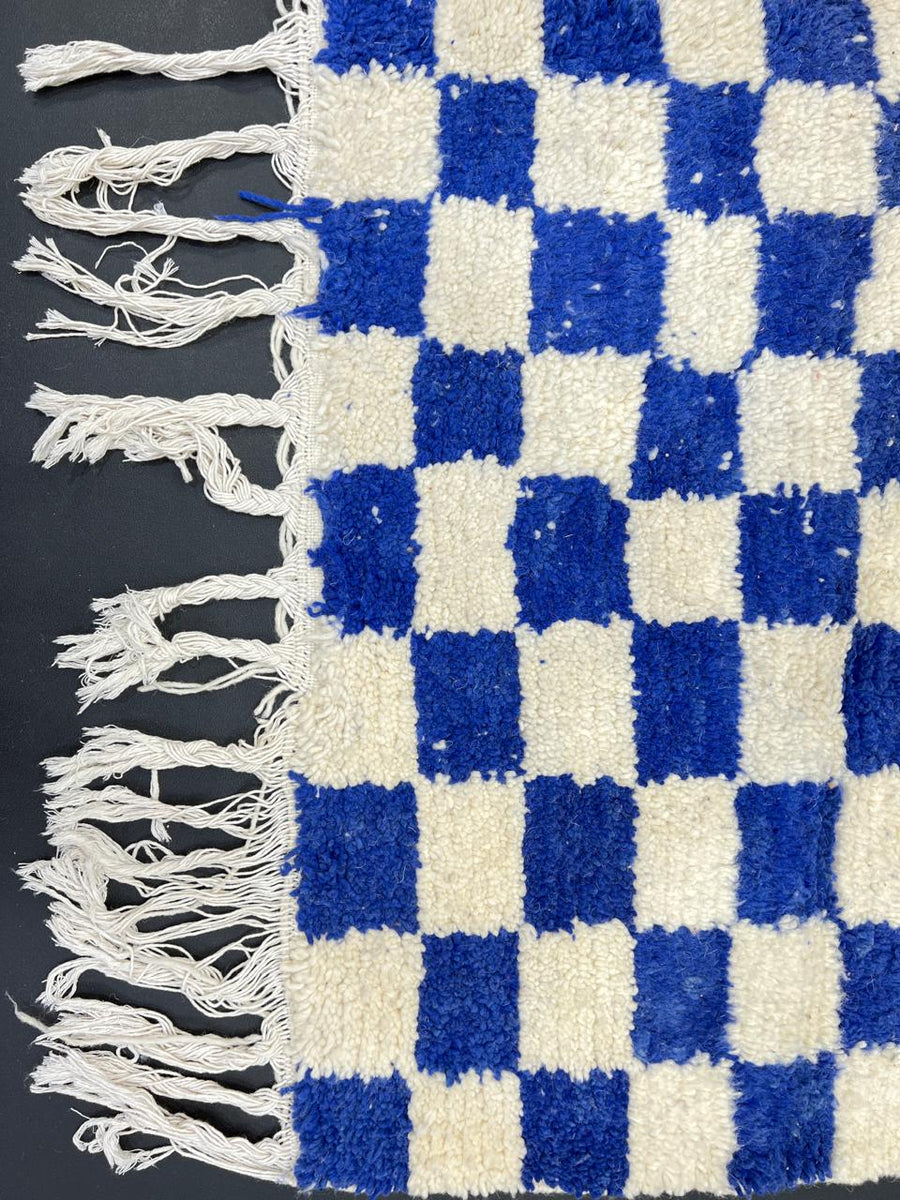 Handmade Moroccan runner rug with blue and white checkerboard pattern crafted from natural wool.