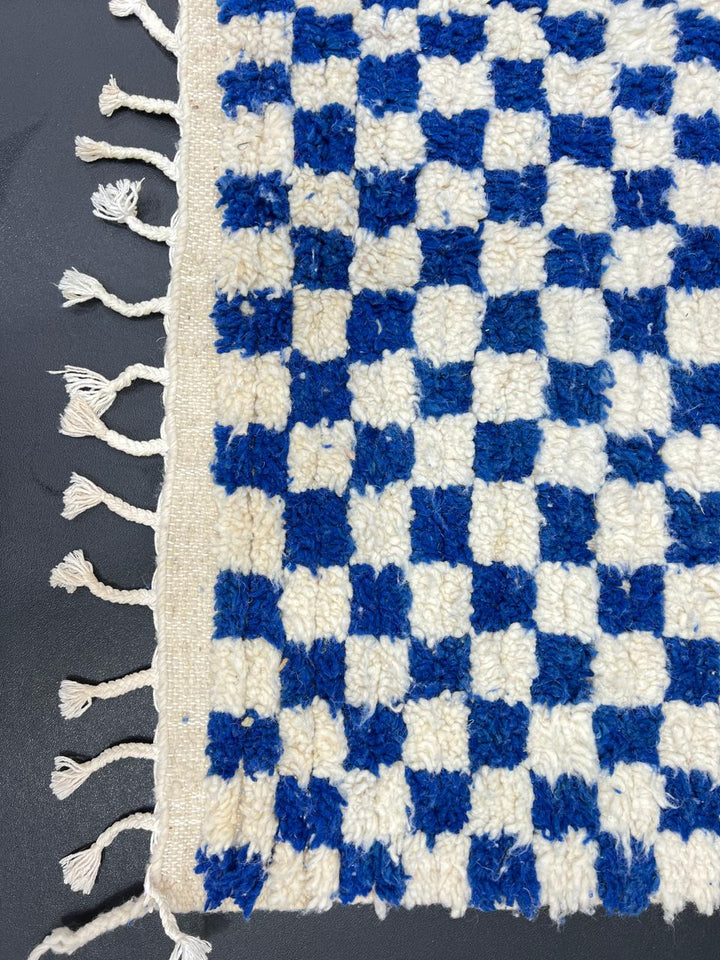 Handwoven blue and cream Moroccan wool rug with checkered design