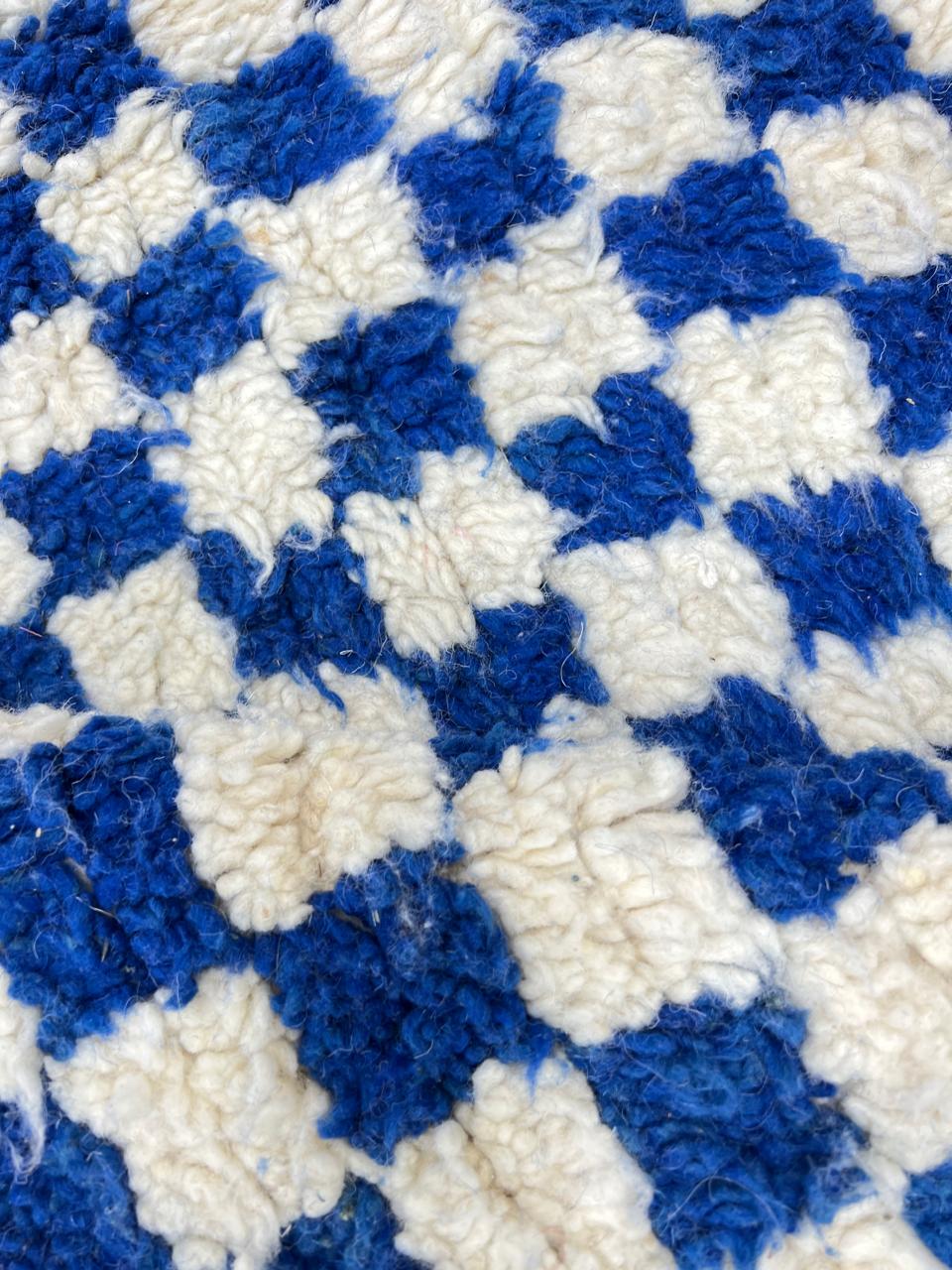 Handwoven blue and cream Moroccan wool rug with checkered design