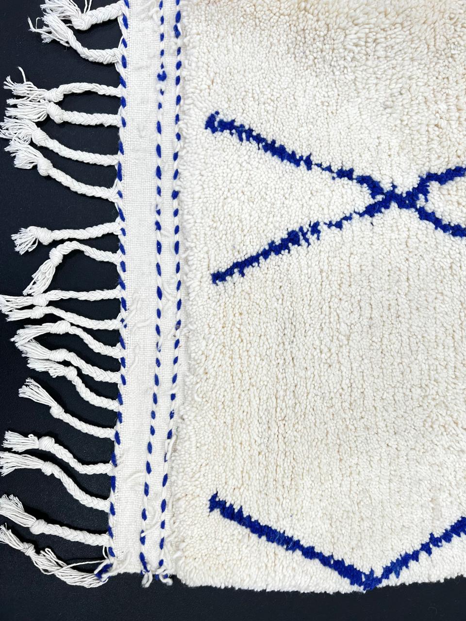 Blue diamond Moroccan runner rug made of natural wool with minimalist Berber pattern on white background and fringed edges