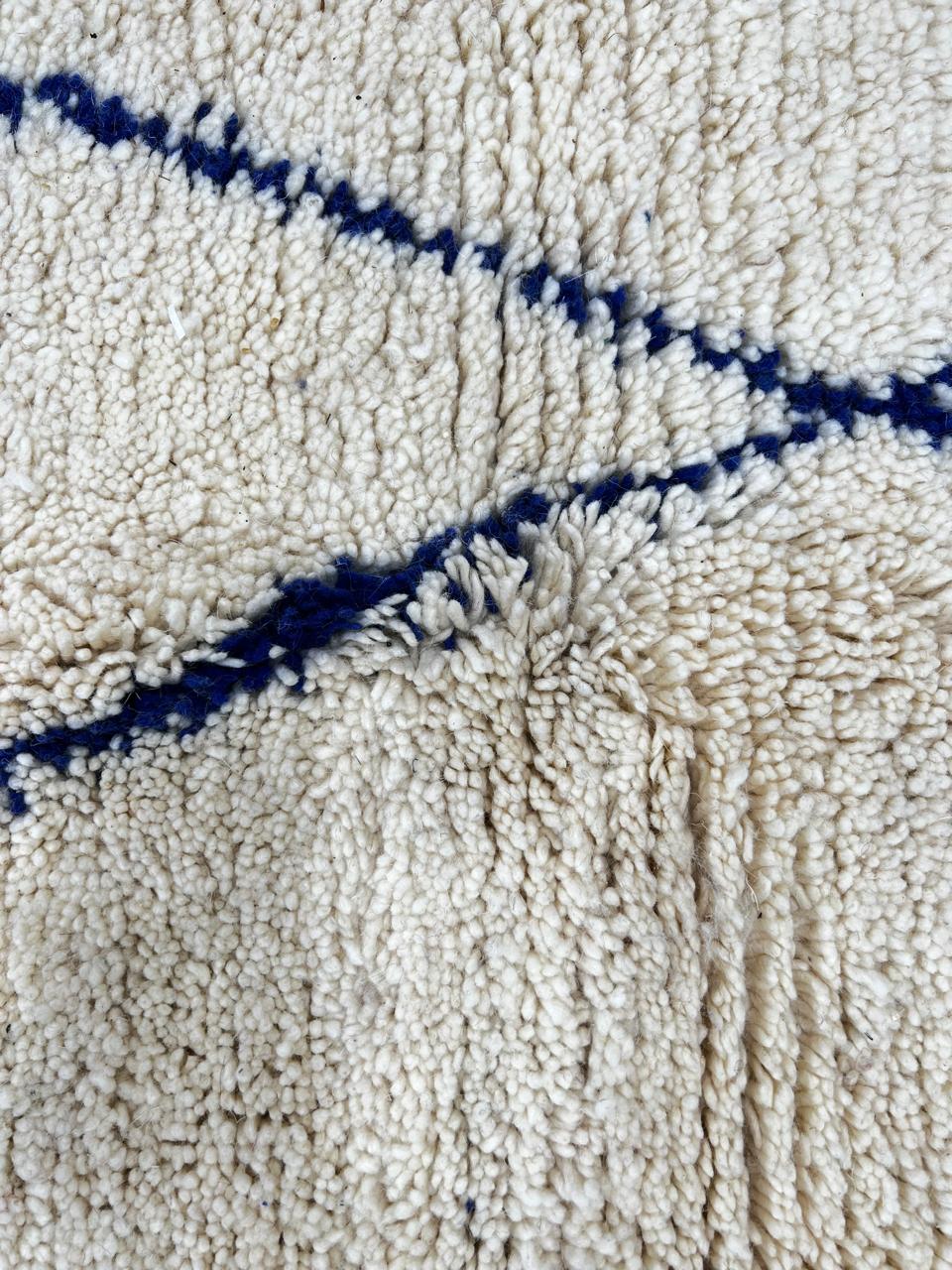 Blue diamond Moroccan runner rug made of natural wool with minimalist Berber pattern on white background and fringed edges