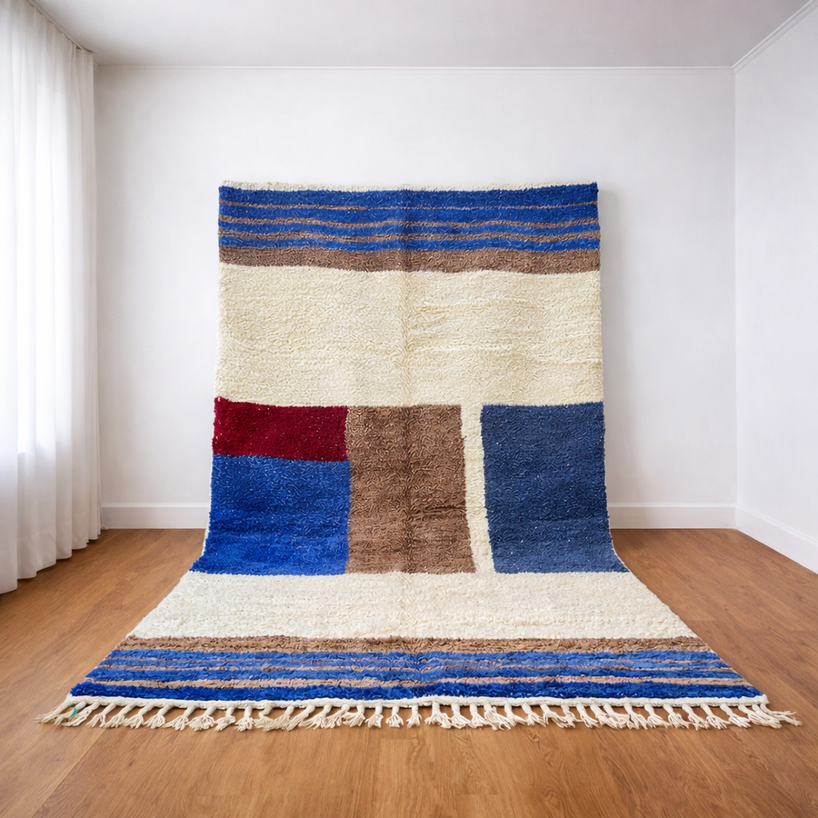 Handmade blue geometric Moroccan wool rug with cream background and Berber color-block design