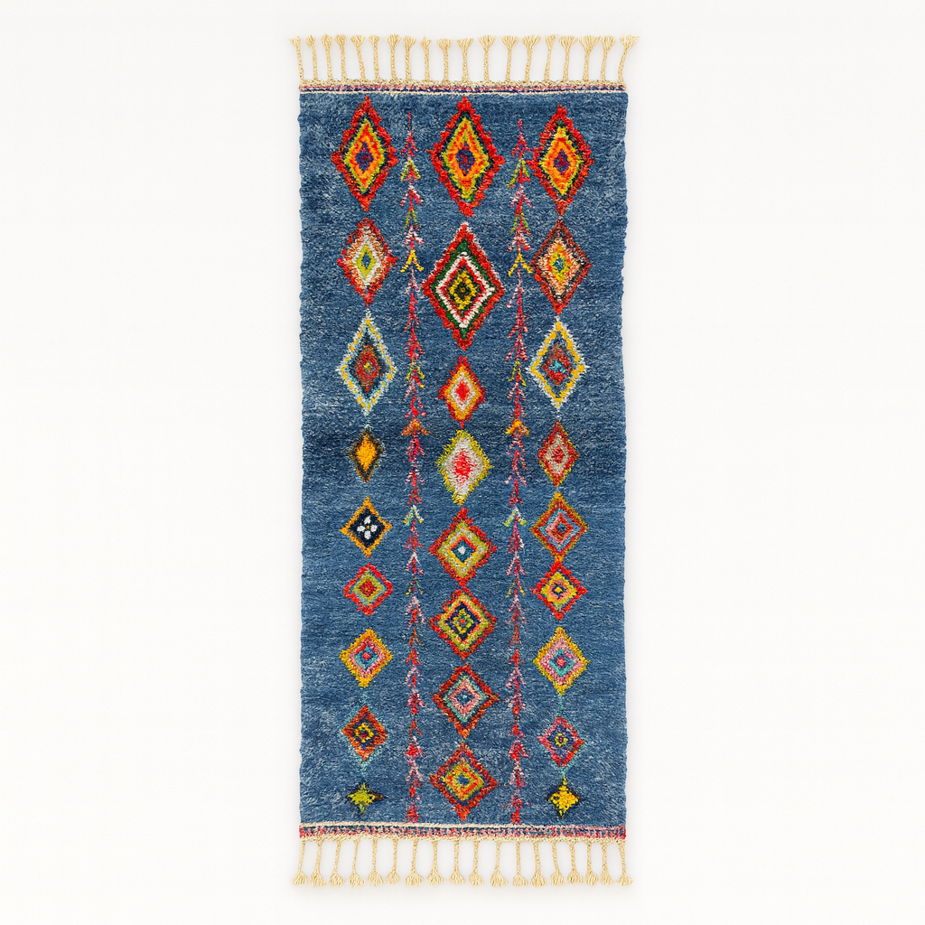 Handmade blue Moroccan runner rug with colorful Berber diamond motifs, crafted from natural wool in a traditional geometric design.