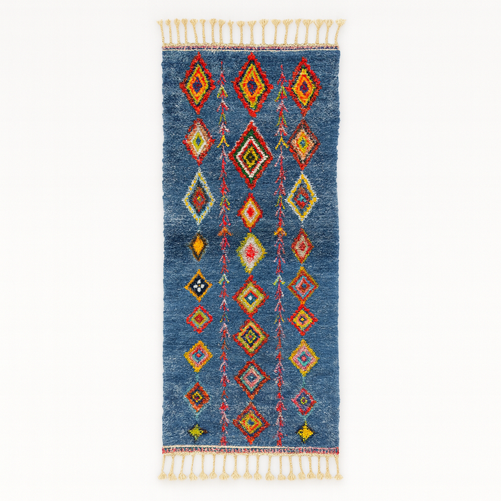 Handmade blue Moroccan runner rug with colorful Berber diamond motifs, crafted from natural wool in a traditional geometric design.
