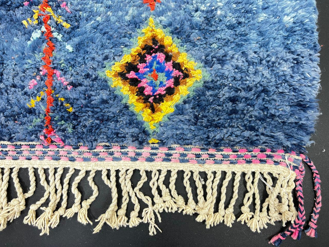 Handmade blue Moroccan runner rug with colorful Berber diamond motifs, crafted from natural wool in a traditional geometric design.