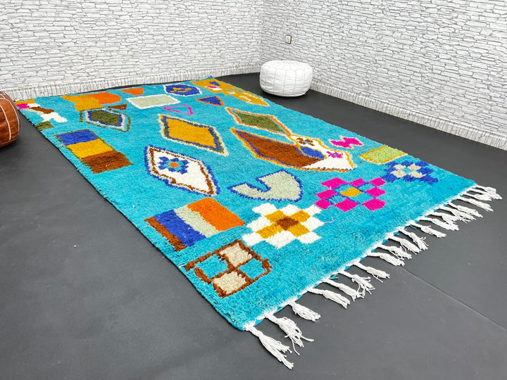 Handwoven blue Moroccan wool rug with colorful geometric Berber motifs