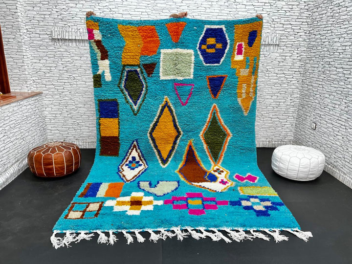 Handwoven blue Moroccan wool rug with colorful geometric Berber motifs