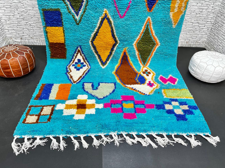Handwoven blue Moroccan wool rug with colorful geometric Berber motifs