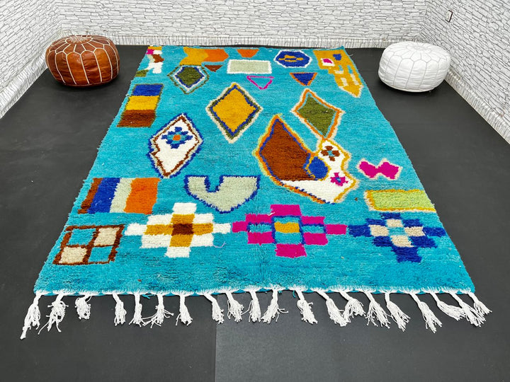 Handwoven blue Moroccan wool rug with colorful geometric Berber motifs