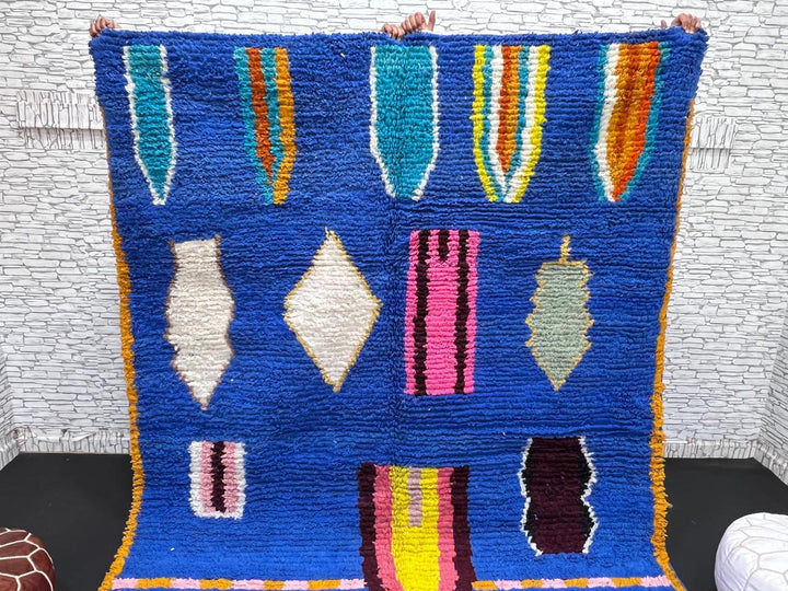 Blue Moroccan wool rug with modern abstract Berber symbols on a plush handwoven surface