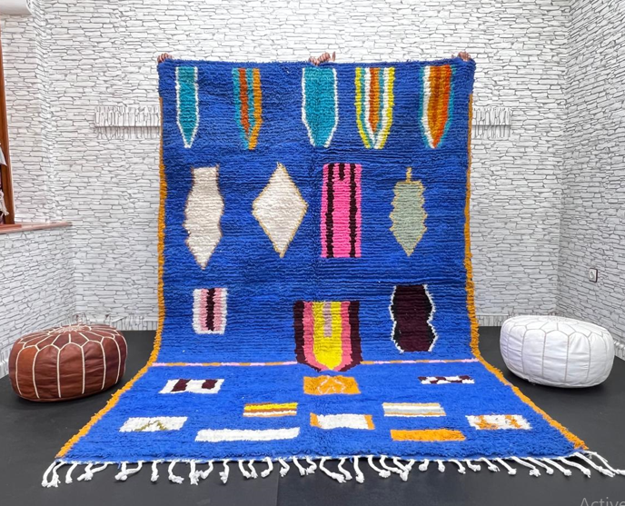 Blue Moroccan wool rug with modern abstract Berber symbols on a plush handwoven surface