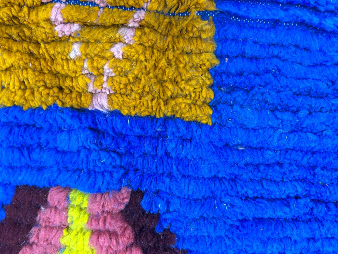 Blue Moroccan wool rug with modern abstract Berber symbols on a plush handwoven surface