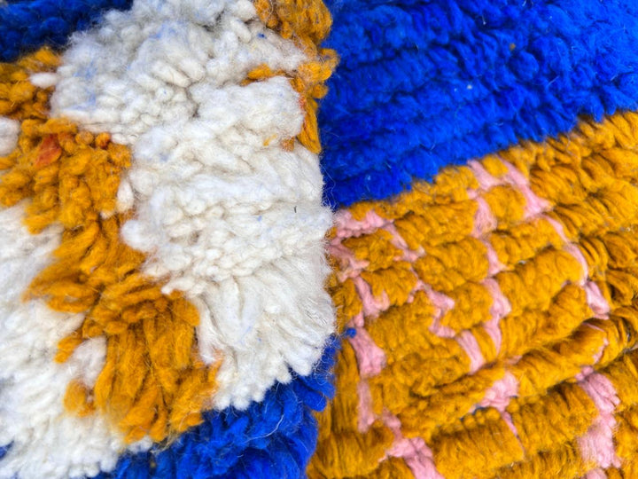Blue Moroccan wool rug with modern abstract Berber symbols on a plush handwoven surface